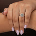 Front finger view of oval shaped diamond engagement ring set in split shank with 14k white gold.