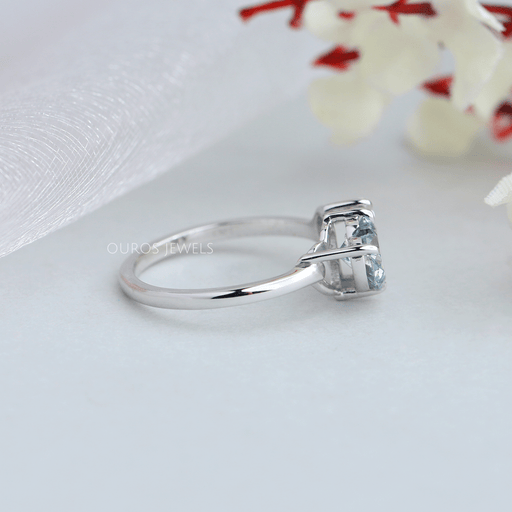 side view of blue heart and pear-cut lab diamond toi et moi wedding ring