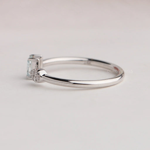 side view of green radiant-cut lab diamond open cuff dainty wedding band on fabric