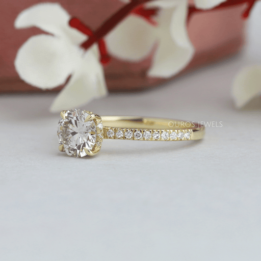 side view of round cut lab diamond solitaire hidden halo engagement ring yellow gold band