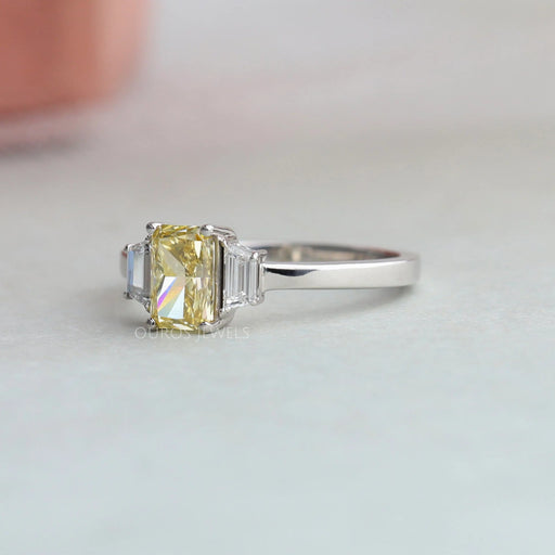 side view of yellow radiant cut lab diamond three stone engagement ring